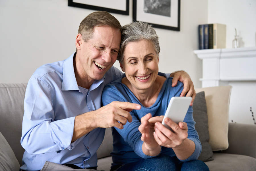 Older couple holding phone looking at a responsive website design for a small business in Central Illinois