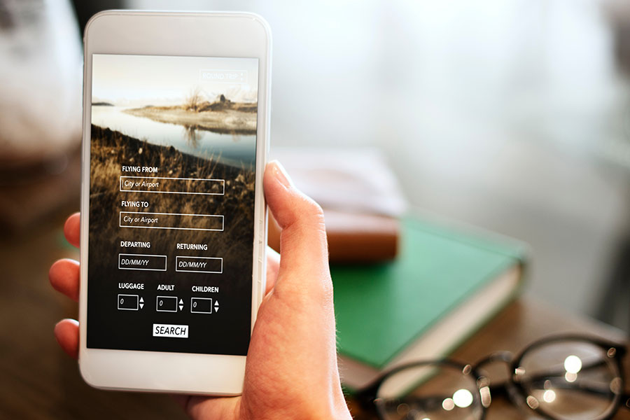 A person holding a smartphone with a local and mobile-responsive website to improve SEO marketing in Decatur, IL.