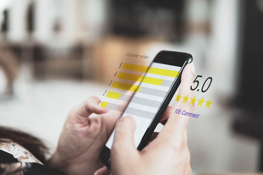 A person holding a smartphone and rating an online-only business in O'Fallon, IL, thanks to expert digital marketing services.