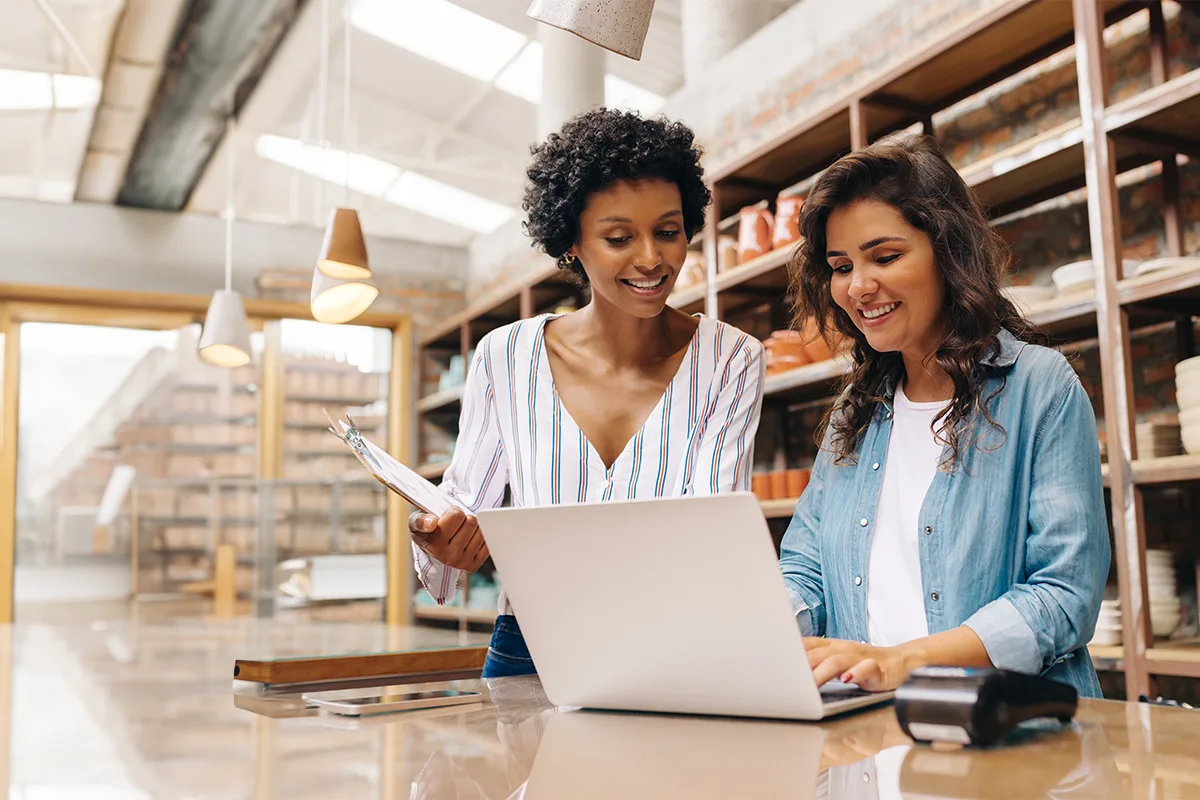 two business owners working on a laptop.