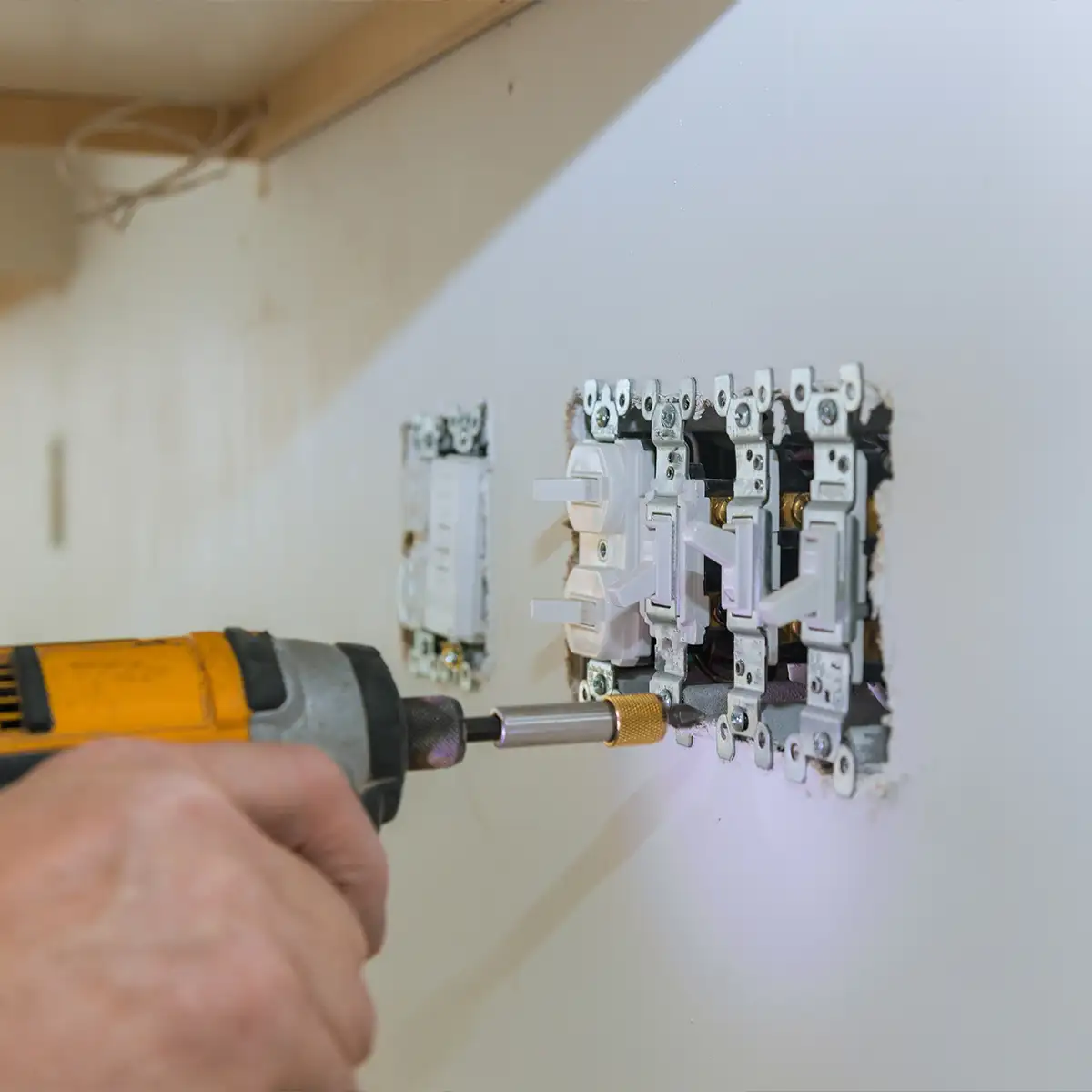 electrician installing a new light switch - electrical company website design Collinsville Illinois - metro east - St. Louis Metro - Central Illinois - Springfield IL