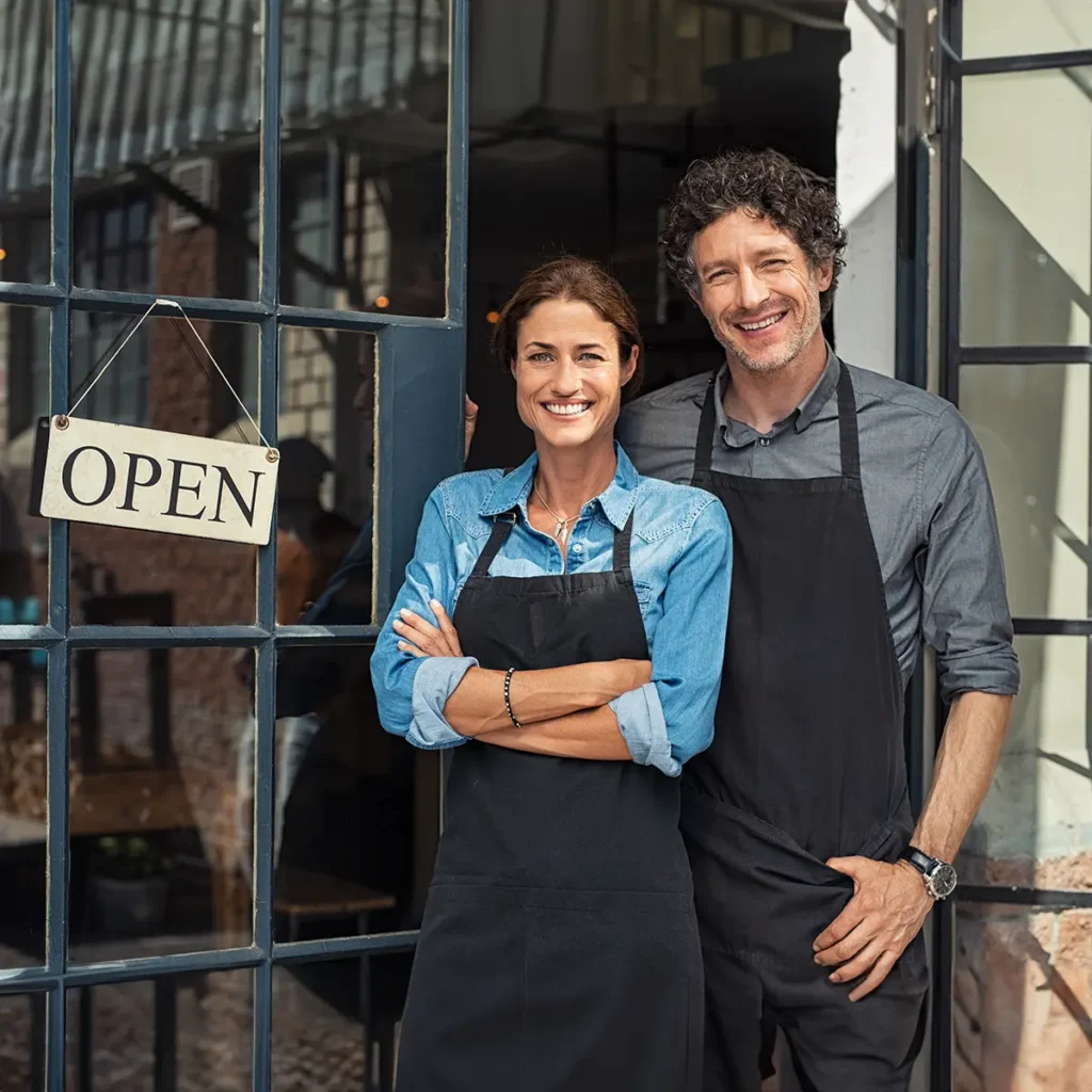 restaurant owners standing outside of their restaurant - website design for restaurants