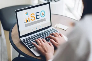 RIGHT CLICK DIGITAL, INC. - A woman working on a laptop with SEO on the screen as she tries to make a website more visible online so customers can find the Collinsville, IL small business.