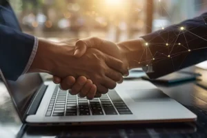 RIGHT CLICK DIGITAL, INC. - A handshake between a businessman and customer through a laptop at an office in Collinsville, IL.