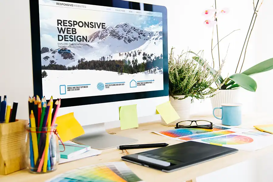 Right Click Digital, Inc.—A desk with a computer showing a screen about responsive website design for a business in St. Louis, MO.