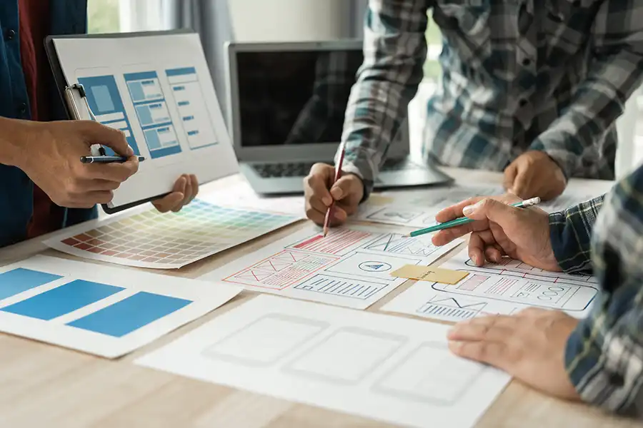 Right Click Digital—Three website designers working together at a website design company to build a client’s website.