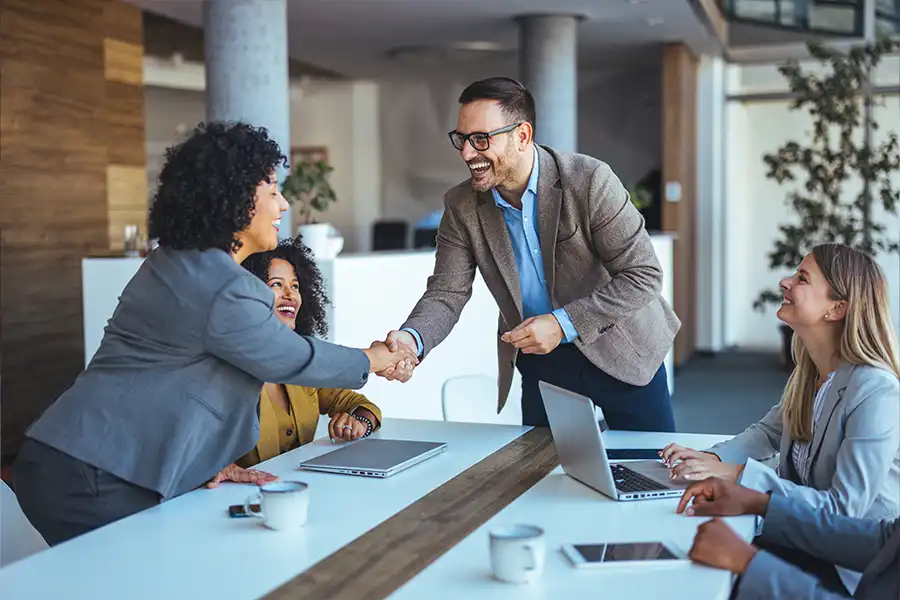 Right Click Digital—A professional team celebrates a successful collaboration in an office in Fairview Heights, IL.