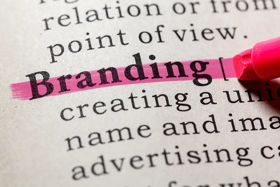 Right Click Digital in Fairview Heights, IL– Close-up of a dictionary page with the word “Branding” highlighted in pink, emphasizing its definition and concept.
