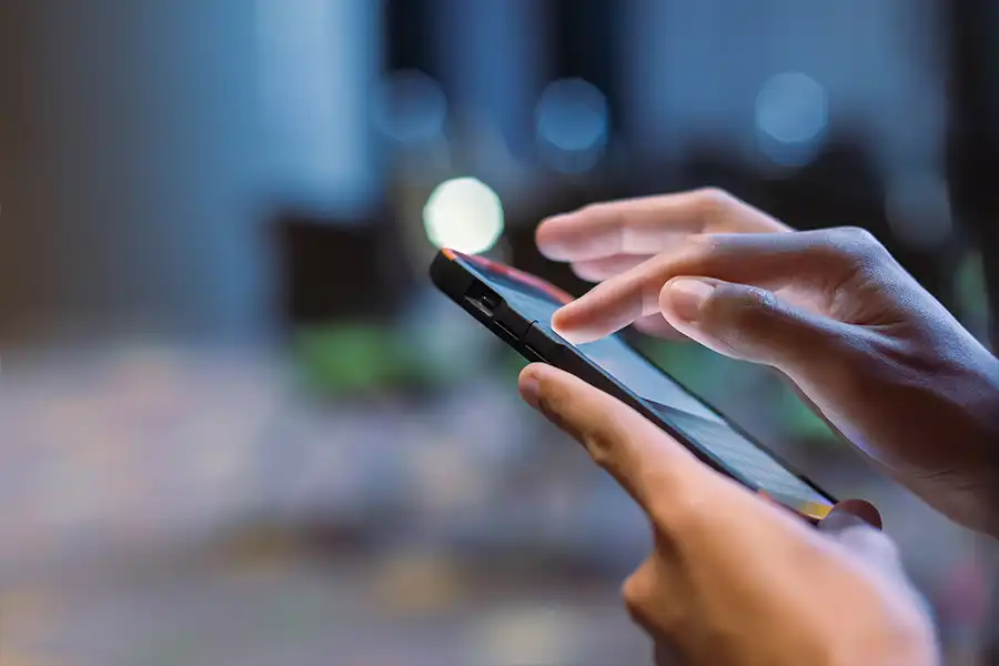 Right Click Digital, Inc. – A person navigating a mobile-friendly website design on his smartphone in Collinsville, Illinois.