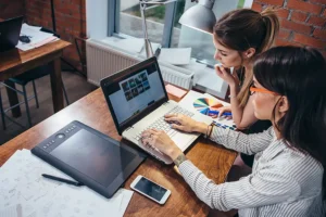 Right Click Digital—Two women in an office posting content for their company’s website in Edwardsville, IL